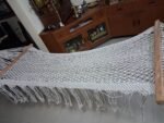 Full length view of handwoven macrame hammock with boho fringes