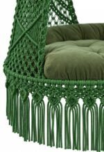 Close-up of green macrame swing knots, fringe and green cushion