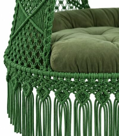 Close-up of green macrame swing knots, fringe and green cushion
