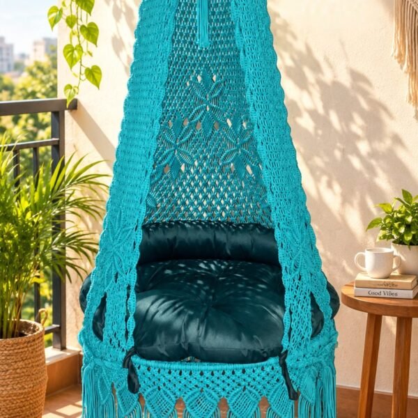40 inch sea green macrame swing with green cushion on a sunny balcony