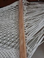 Close-up of wooden spreader bar and knots on macrame hammock