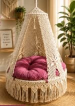 50 inch natural cotton macrame swing with pink cushion in a living room