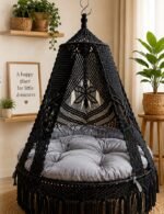 60 inch black macrame swing with grey cushion in a living room
