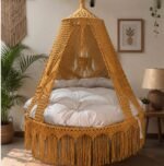 60 inch mustard macrame swing with cream cushion in a living room