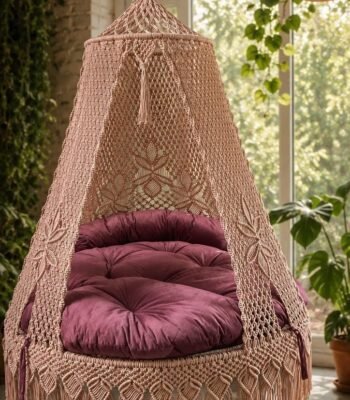 60 inch natural light pink macrame swing with pink cushion near a window