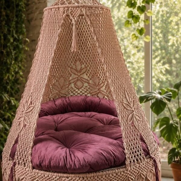 60 inch natural light pink macrame swing with pink cushion near a window