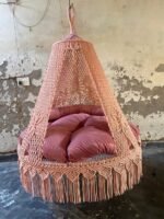 Actual photo of the 60 inch natural light pink macrame swing with pink cushion