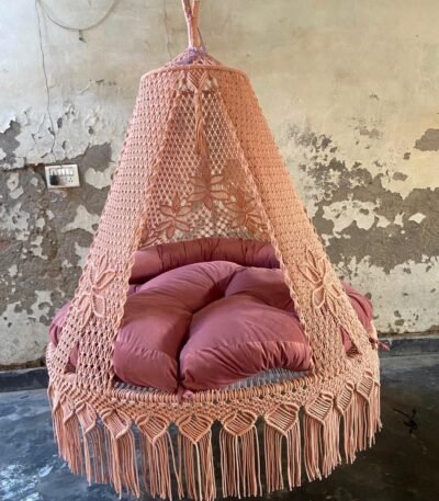 Actual photo of the 60 inch natural light pink macrame swing with pink cushion