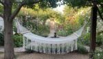 Macrame hammock in a flower garden