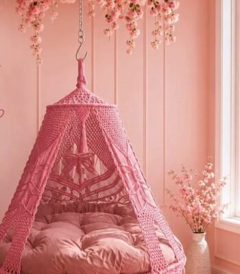 70 inch baby pink macrame swing with pink cushion in a pink room