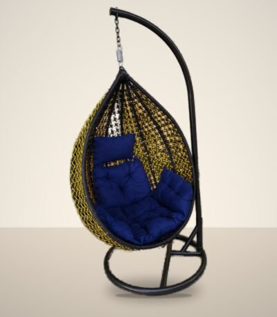 Black and yellow HDPE wicker hanging egg chair swing with stand and navy blue cushions, studio background