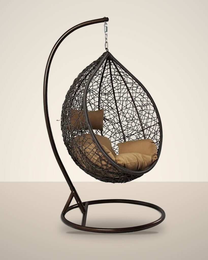 Brown HDPE wicker hanging egg chair swing with stand and tan cushions, studio background
