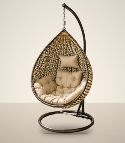 Gold and black HDPE wicker hanging egg chair swing with stand and beige cushions, studio background