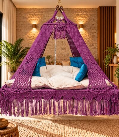 ProKnots Queen Size macrame bed swing jhula in a living room, with mattress and blue cushions